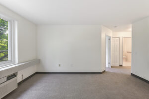 Interior Unit Living Room, new carpeting, AC Unit below window,