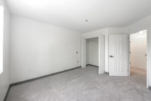Interior Unit Bedroom, accordion closet doors, new carpeting, White Walls