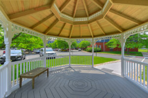Interior shot of outdoor gazebo, parking nearby, meticulously groomed grounds.